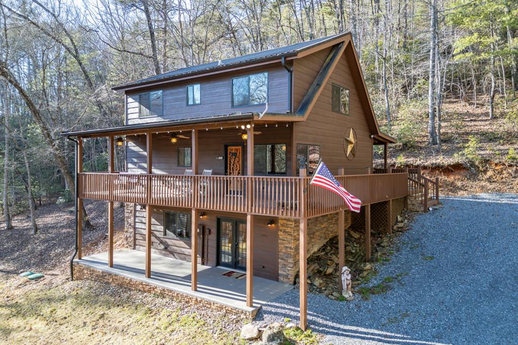 1454 Ritchie Creek Road Blue Ridge, GA 30513 - Photo 1 of 3 a front view of a house with a porch