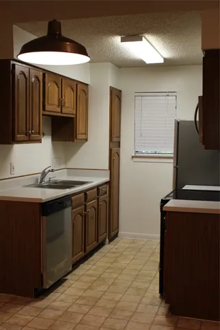a kitchen with a sink and a refrigerator