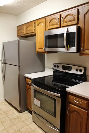 a kitchen with stainless steel appliances granite countertop a stove and a microwave