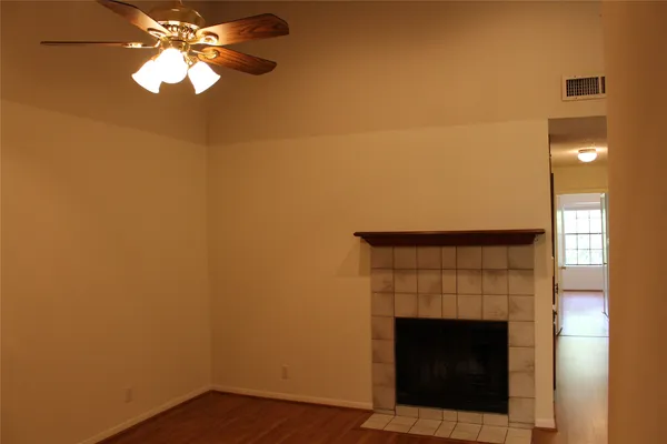 a room with a fireplace and chandelier