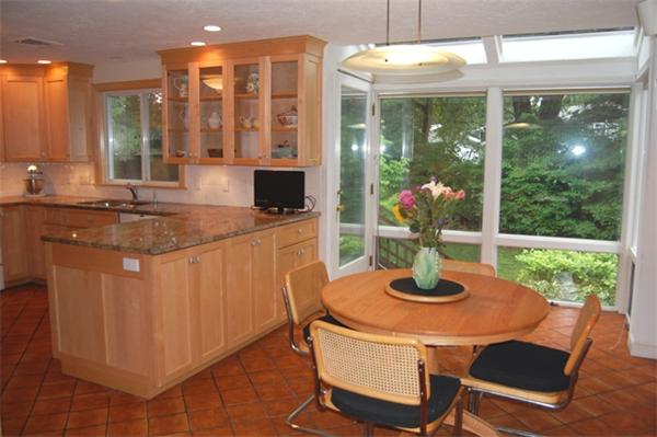 11 John Poulter Road Lexington, MA 02421 - Photo 11 of 27 a kitchen with a table chairs and microwave