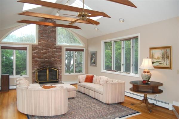 11 John Poulter Road Lexington, MA 02421 - Photo 3 of 27 a living room with furniture a fireplace and a table