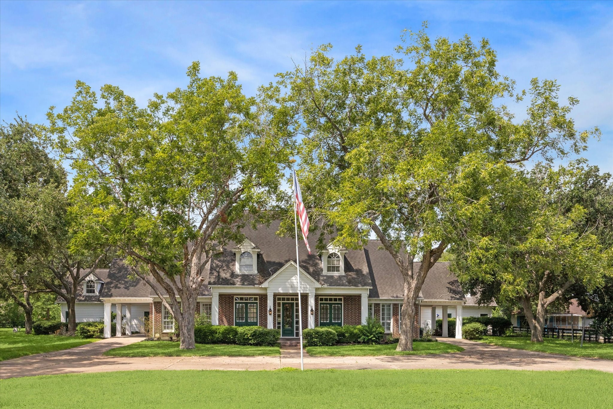 3577 Katy Hockley Road Katy, TX 77493 - Photo 1 of 50 The stately home sits gracefully among mature trees, its timeless architecture creating an inviting first impression.