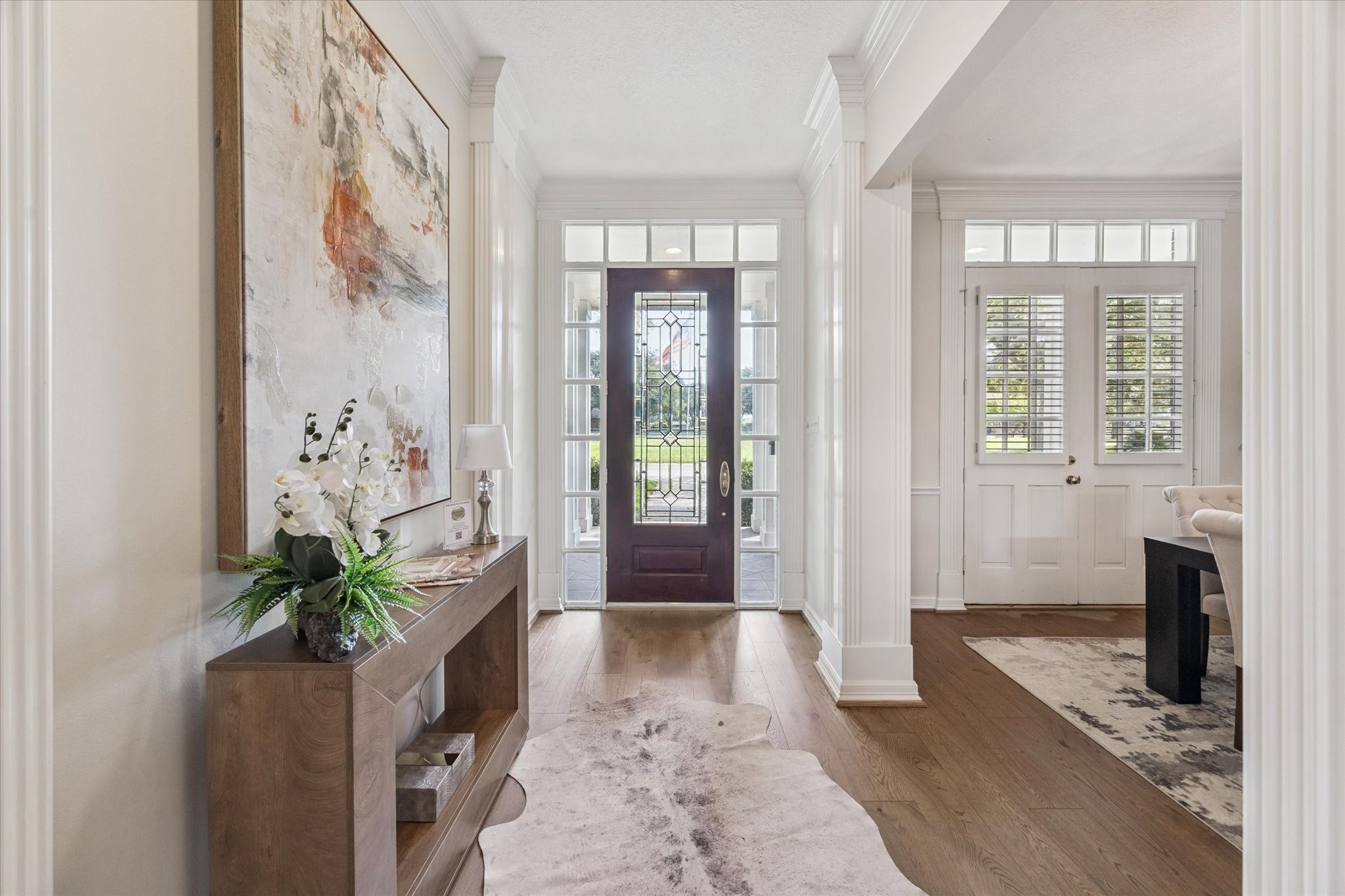 3577 Katy Hockley Road Katy, TX 77493 - Photo 16 of 50 The entryway welcomes with elegant glass-paneled doors, transom windows, and warm wood flooring.