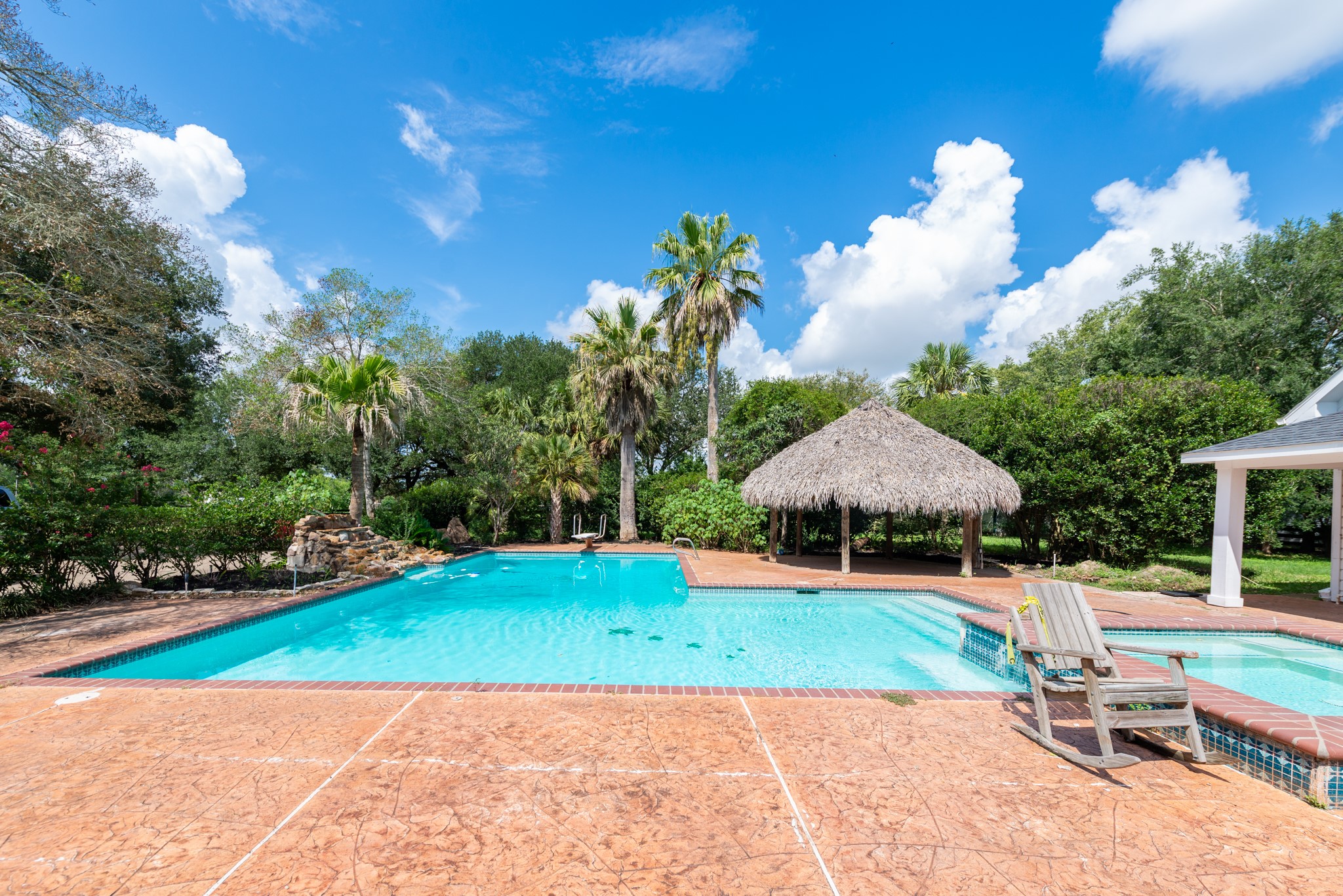 3577 Katy Hockley Road Katy, TX 77493 - Photo 7 of 50 The sparkling resort-style pool glistens beneath the Texas sun, complete with a cascading rock waterfall.