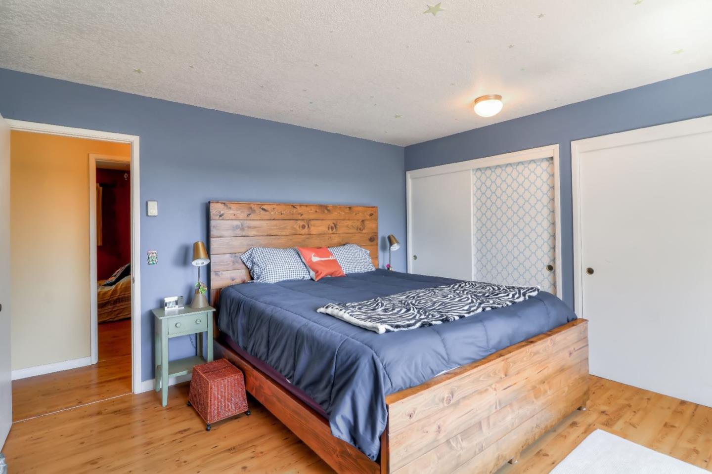 809 C Lewis Road Watsonville, CA 95076 - Photo 14 of 41 a bedroom with a bed and wooden floor