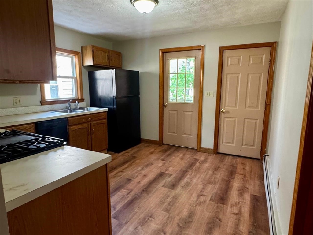 68 Maverick Street Chelsea, MA 02150 - Photo 5 of 16 a kitchen with a refrigerator stove and sink