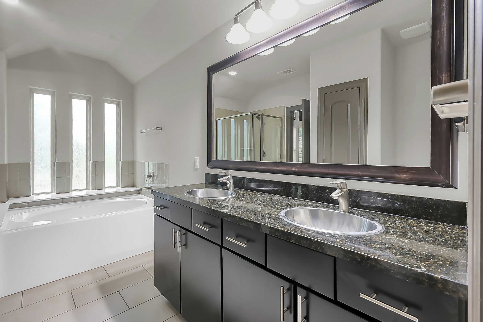 18 Aventura Place Spring, TX 77389 - Photo 23 of 43 a bathroom with a granite countertop sink a large mirror a and window