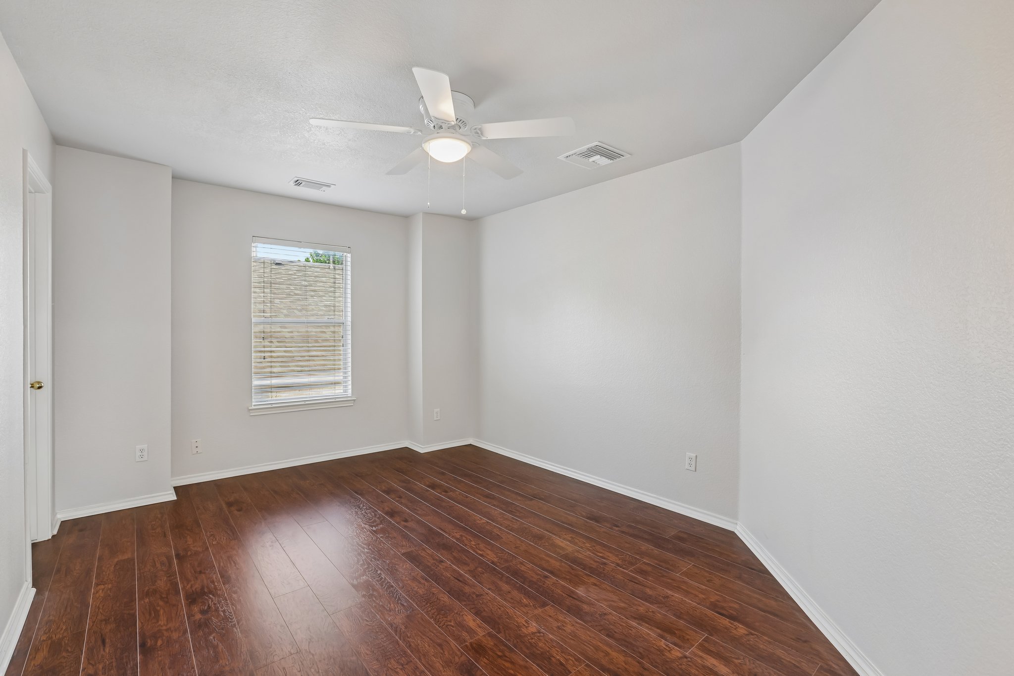 1721 Long Rifle Drive Austin, TX 78754 - Photo 27 of 38 Rich hardwood floors complement this well-lit room, ideal for relaxation or a productive workspace.