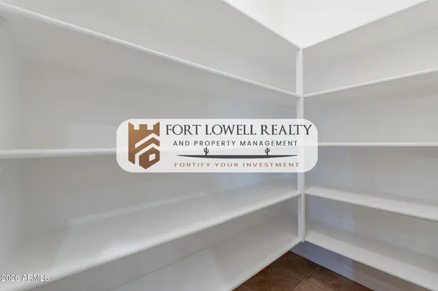 a view of a room with lots of wooden furniture