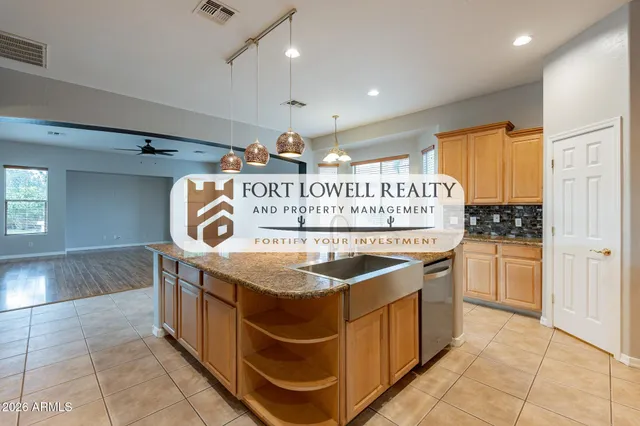 a kitchen with stainless steel appliances granite countertop a stove a sink and a window
