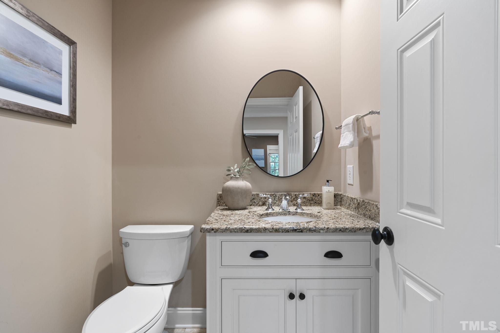 3329 Hampton Road Raleigh, NC 27607 - Photo 28 of 46 a bathroom with a toilet sink and mirror