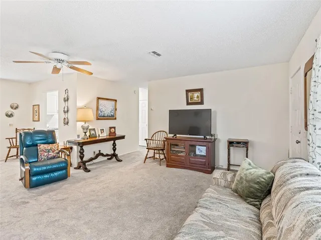 a view of a dining room with furniture and a chandelier