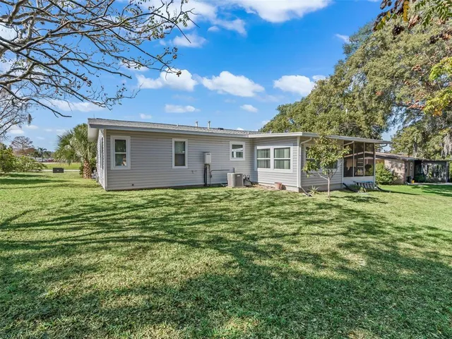 an aerial view of a house with a yard basket ball court and outdoor seating