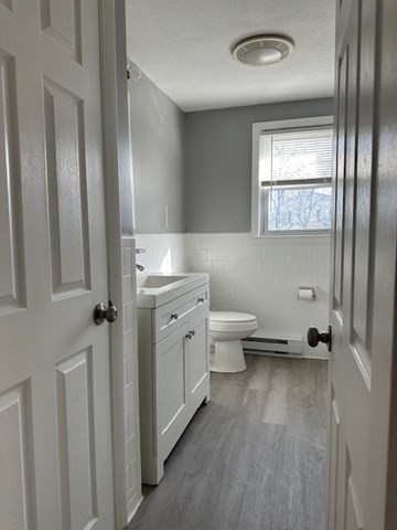 396 Brown Street Attleboro, MA 02703 - Photo 15 of 19 a bathroom with a granite countertop toilet a sink and a large mirror