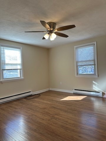 396 Brown Street Attleboro, MA 02703 - Photo 17 of 19 a view of an empty room with wooden floor and a window