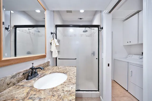 a bathroom with a granite countertop sink mirror and double