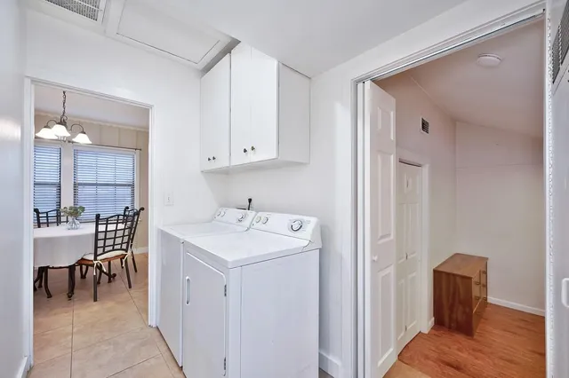 a view of a hallway with kitchen view and living room