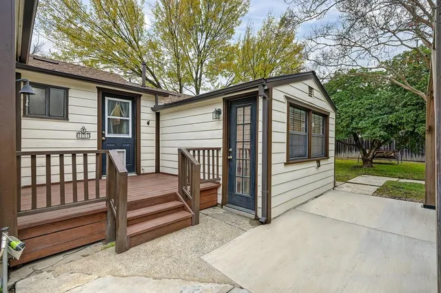 a view of a house with a yard and wooden fence