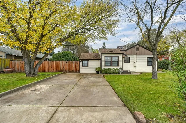 a front view of a house with yard and green space