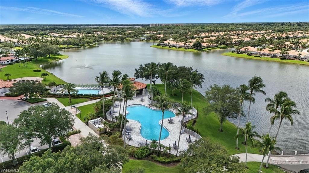 an aerial view of residential houses with outdoor space and lake view