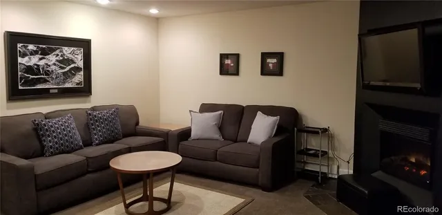 a living room with furniture a couch and a flat screen tv