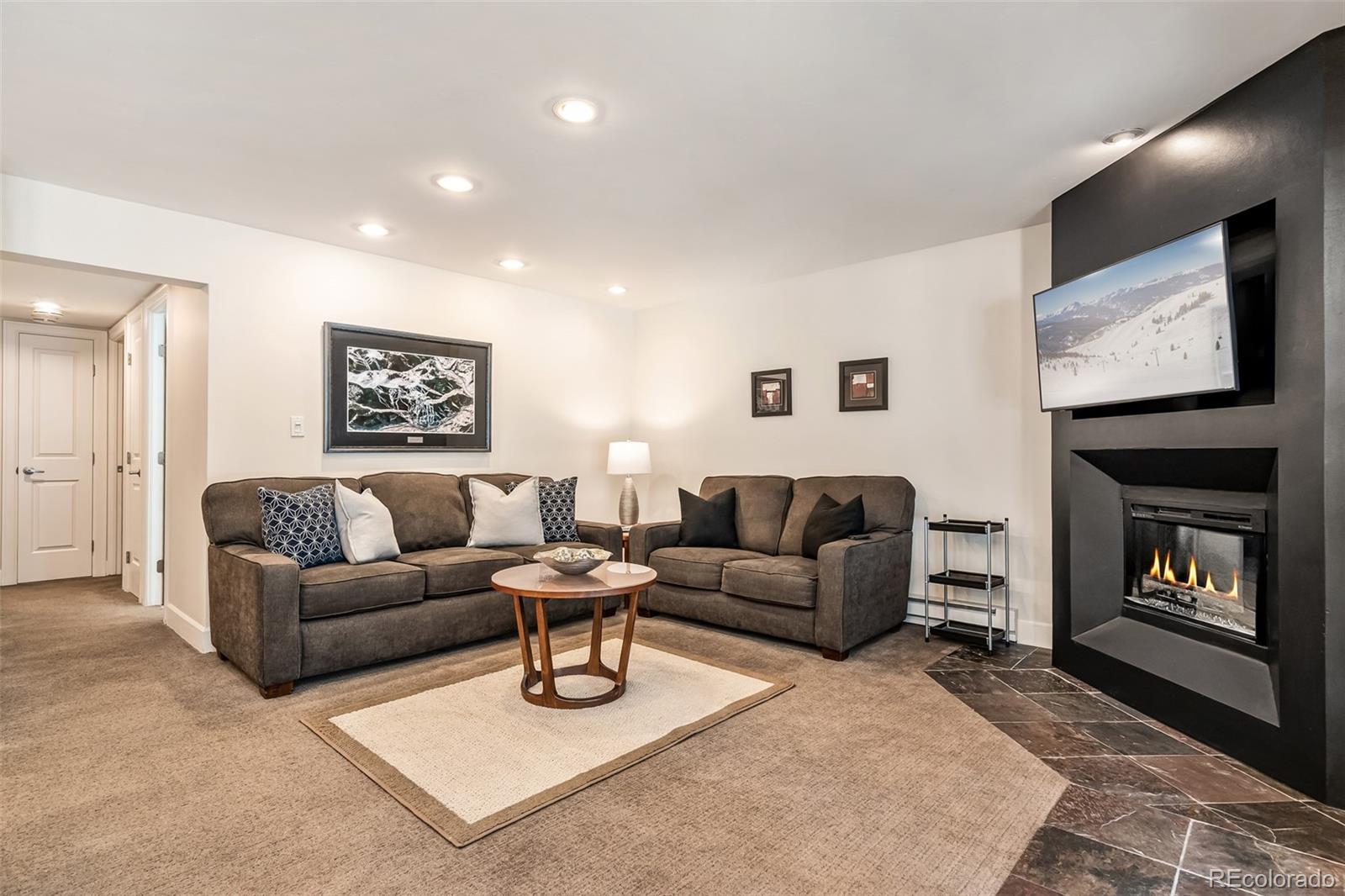 4660 Vail Racquet Club Drive, Unit 2 Vail, CO 81657 - Photo 3 of 15 a living room with furniture and a fireplace