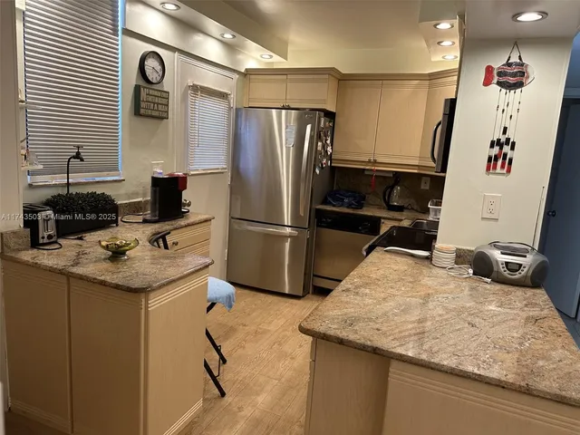 a kitchen with a refrigerator sink and stove top oven