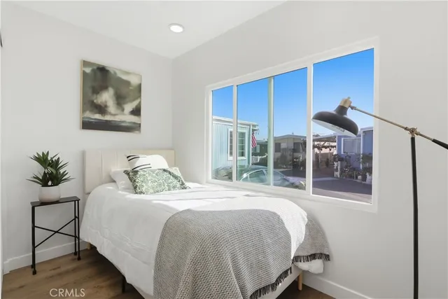 a bedroom with a bed and a painting on the wall