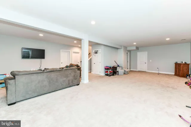 a large bedroom with a bed and cabinets