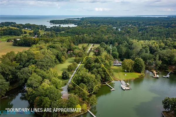 an aerial view of a house with a garden and lake view