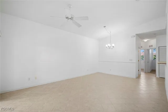 an empty room with a empty space and windows