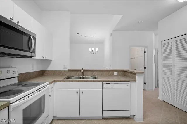 a kitchen with a sink stainless steel appliances and cabinets