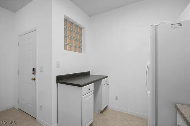 a utility room with cabinets washer and dryer