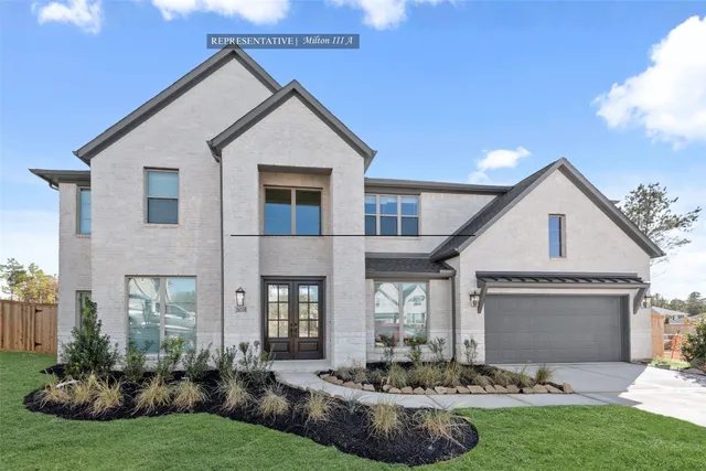 a front view of a house with a yard and outdoor seating