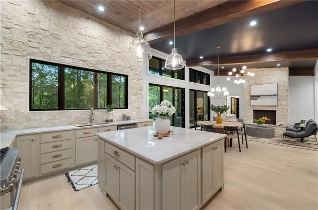 a living room with fireplace furniture and a large window