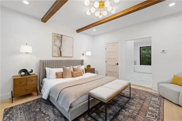 a bathroom with a tub double sink mirror and window