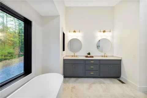 a bathroom with a granite countertop sink a toilet and shower