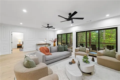 a view of a balcony with chairs and wooden floor