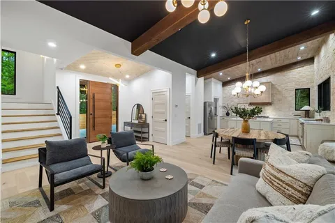 a view of a dining room with furniture and chandelier