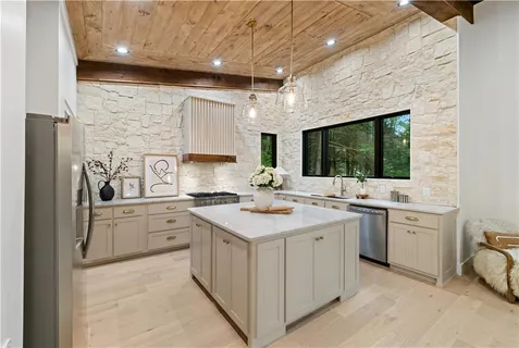 a view of a dining room with furniture a livingroom and chandelier