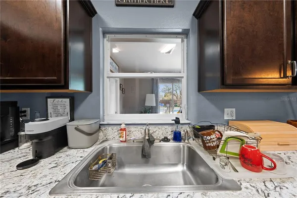 a kitchen with a stove a sink and cabinets