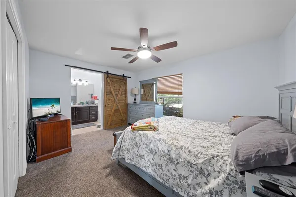 a bedroom with a bed dresser and a window