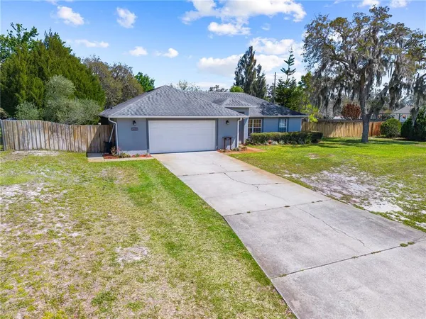 a front view of house with yard and trees