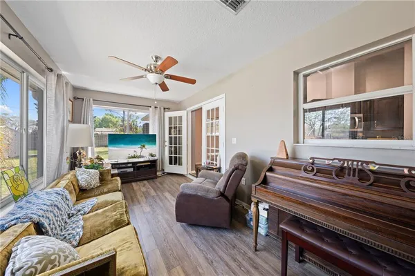 a living room with furniture a fireplace and a flat screen tv