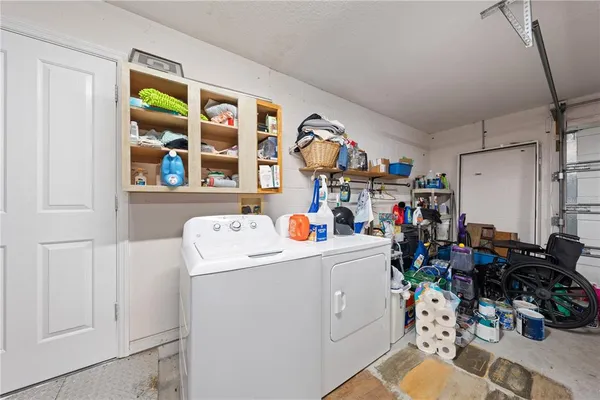 a view of storage and utility room with washer and dryer