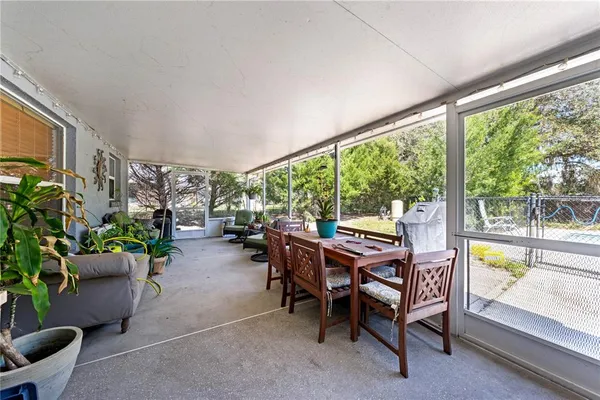 a dining room with furniture and a floor to ceiling window