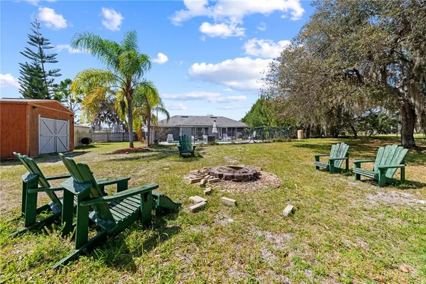 a view of a swimming pool with a patio and a yard