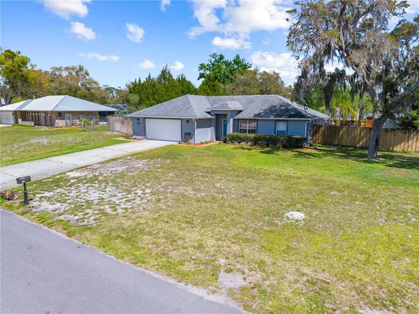 a view of a house with pool and sitting area
