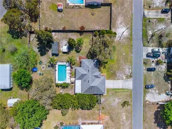 an aerial view of a house with a yard